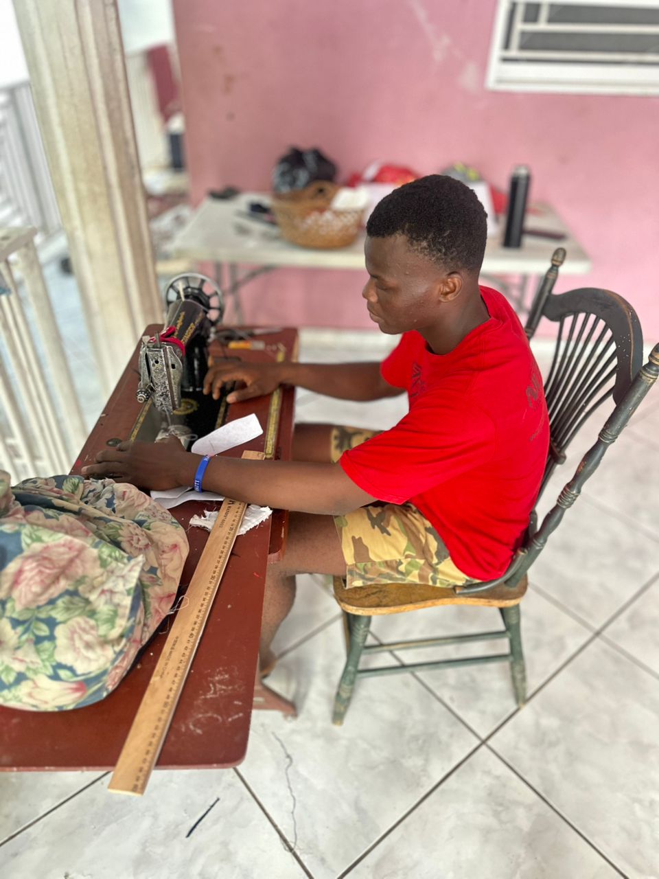 A young person learning to sew at House of Hope in Haiti